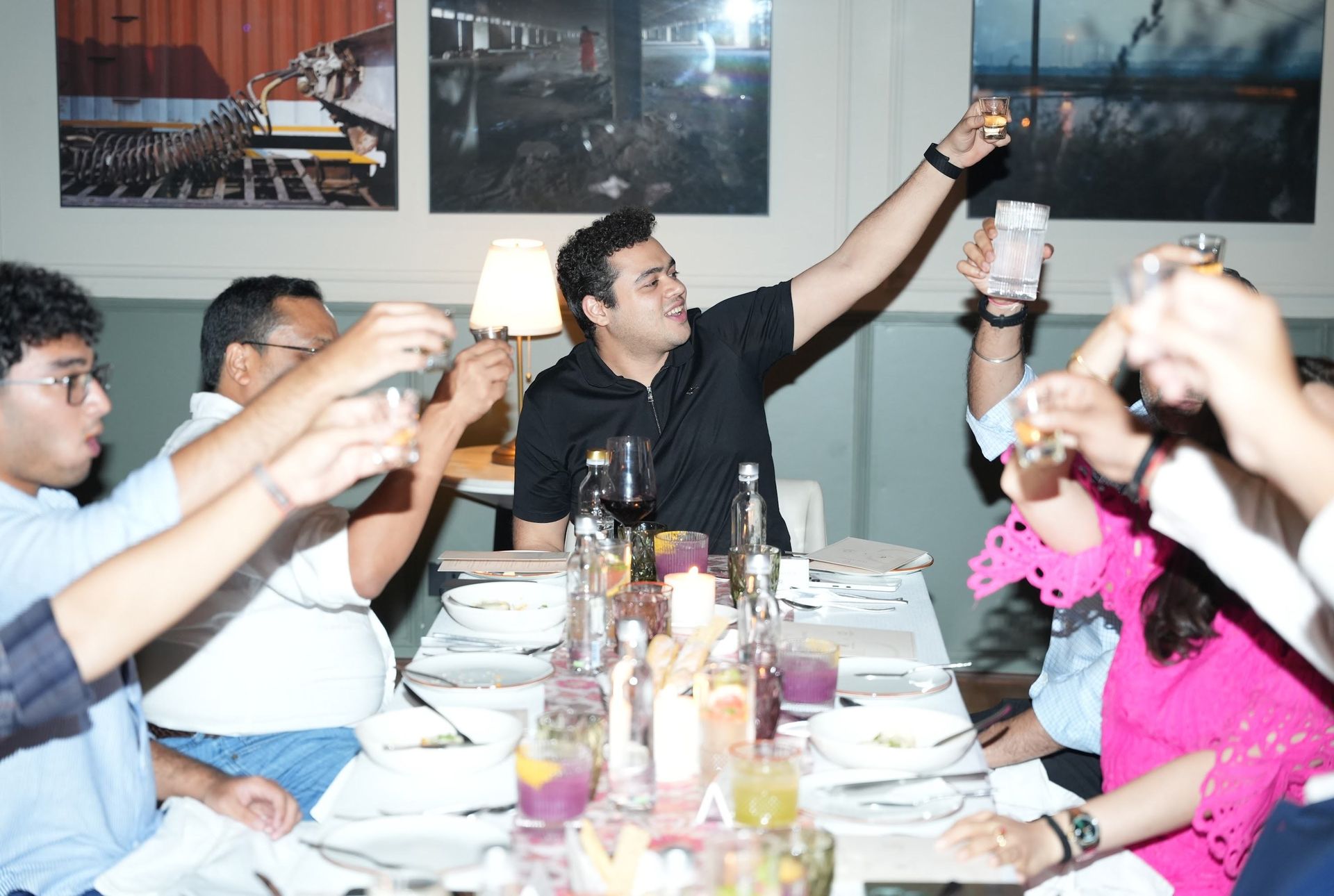 Members raising a toast around a dinner table.