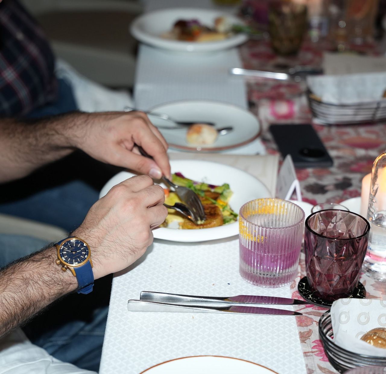 A plated course being set down at a members’ dinner.