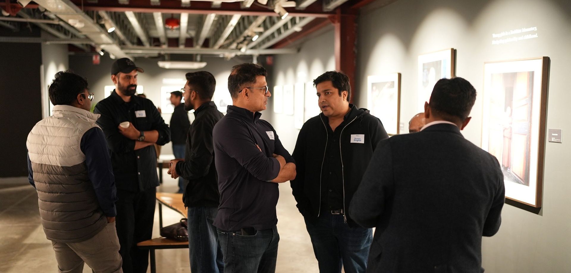 Founders standing in conversation before a session.
